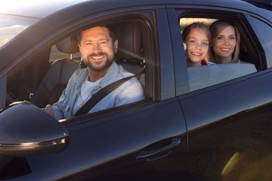 Happy family enjoying trip together by car, view from outside