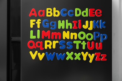 Alphabetical order. Many bright magnetic letters on fridge