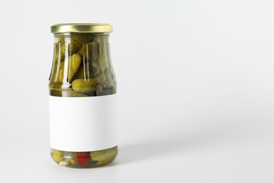 Photo of Pickled cucumbers in jar on light background. Space for text