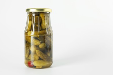 Photo of Pickled cucumbers in jar on light background. Space for text