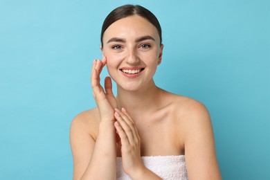 Photo of Beautiful young woman with healthy skin on light blue background