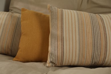 Photo of Soft colorful pillows on sofa at home