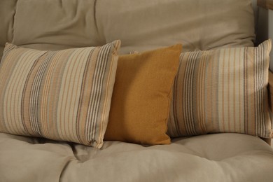 Soft colorful pillows on sofa at home