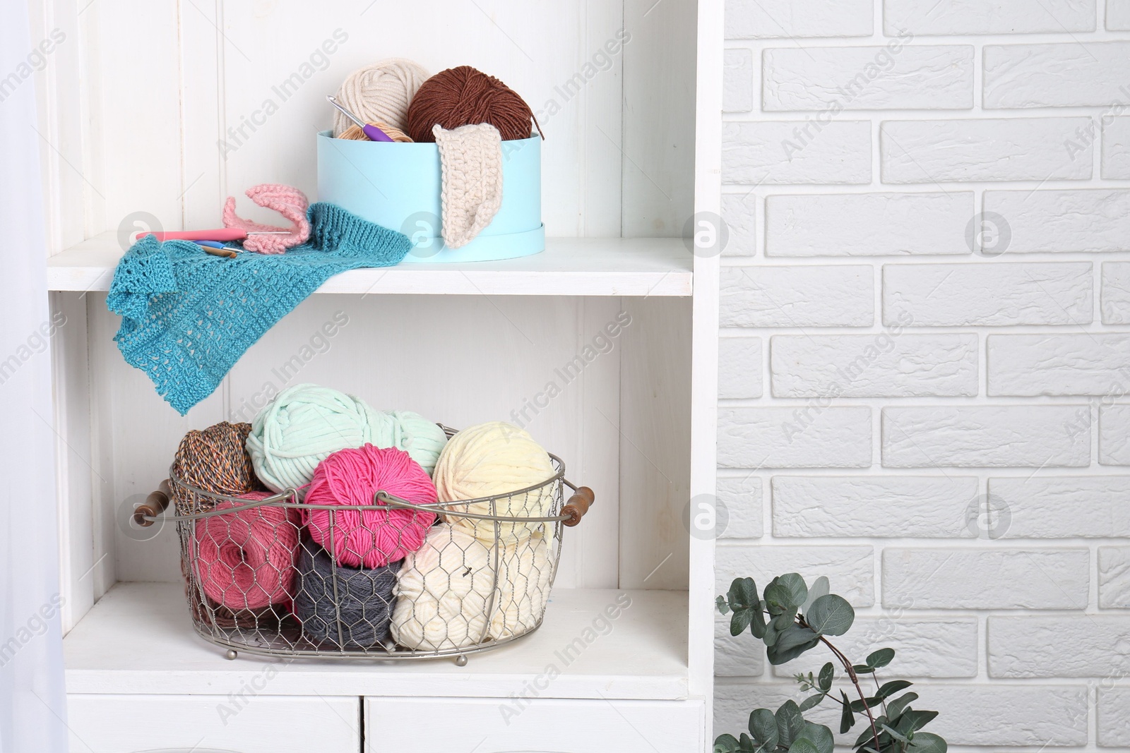 Photo of Shelving unit with different yarns, pattern samples and crochet hooks