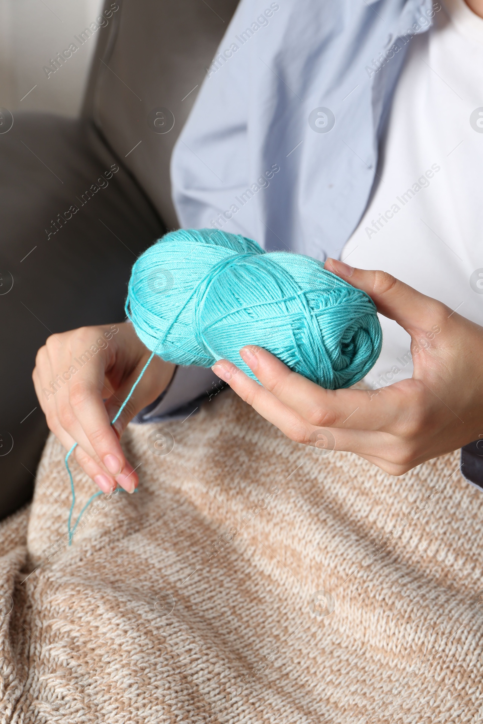 Photo of Woman holding light blue yarn, closeup view