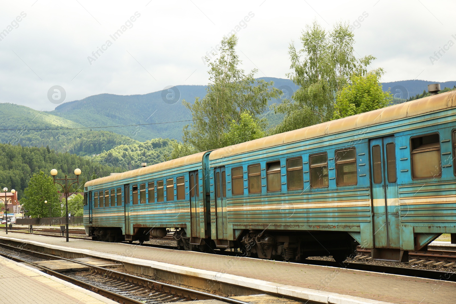 Photo of Old train on railway station in mountains