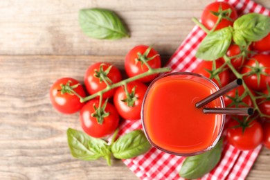 Fresh tomato juice in glass on wooden table, top view. Space for text