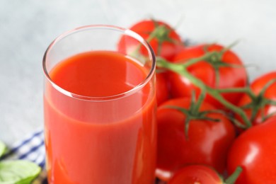 Photo of Fresh tomato juice in glass on table, closeup