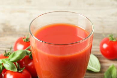 Fresh tomato juice in glass on table, closeup