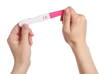 Woman holding pregnancy test on white background, closeup