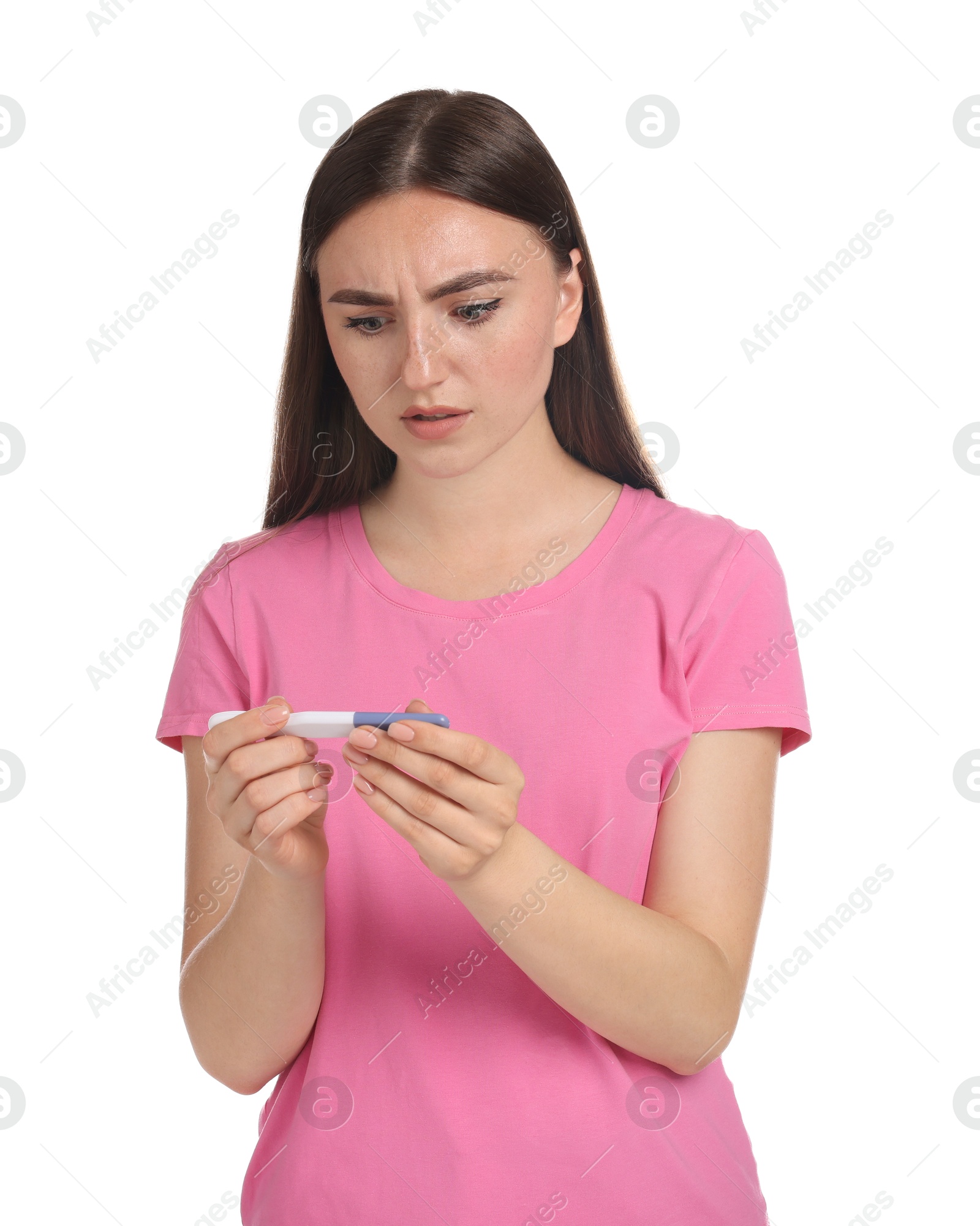 Photo of Confused woman holding pregnancy test on white background