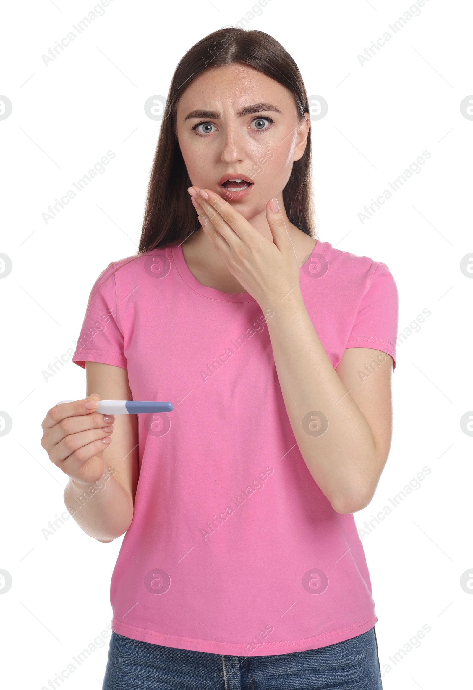 Photo of Shocked woman holding pregnancy test on white background