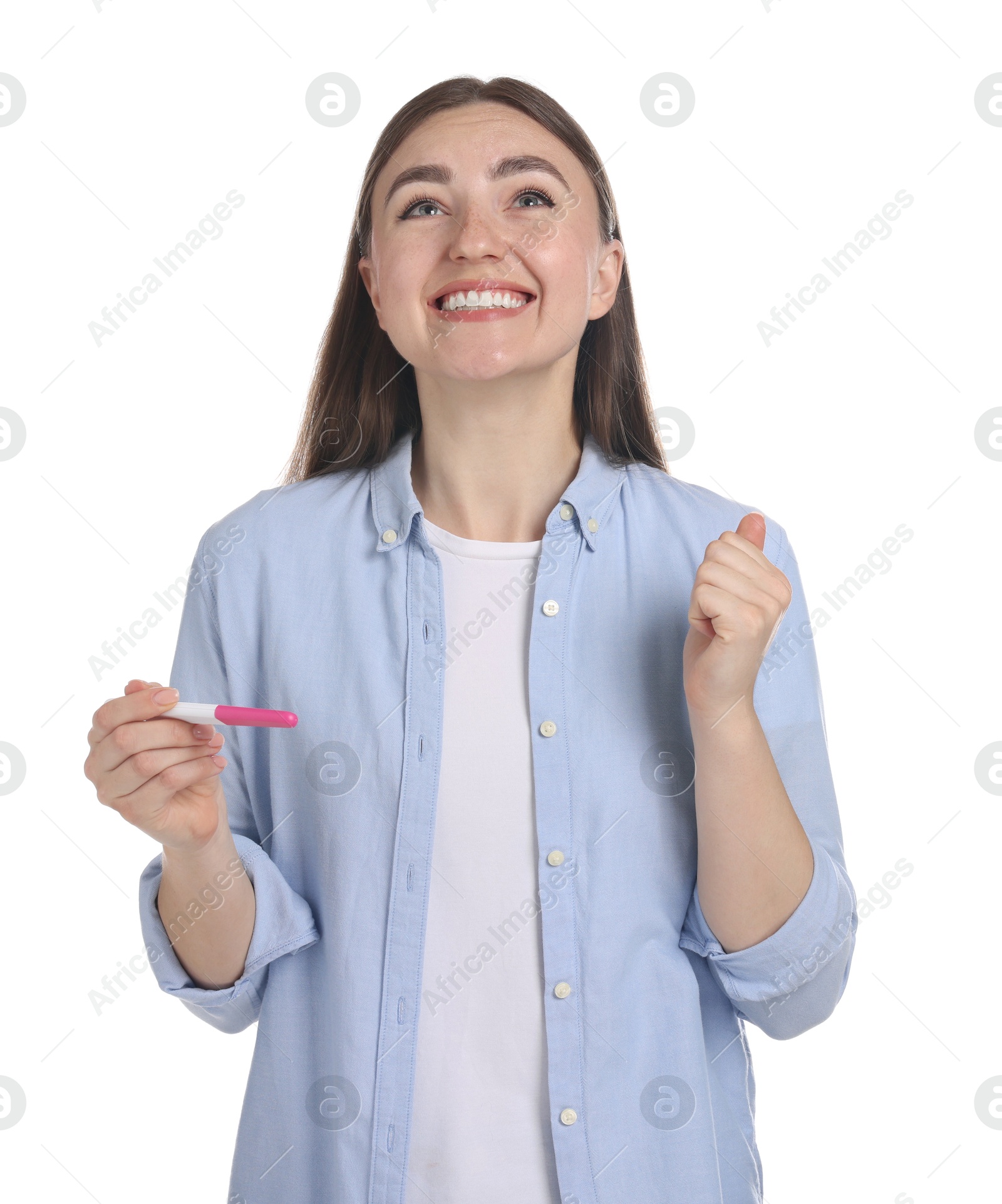 Photo of Happy woman holding pregnancy test on white background