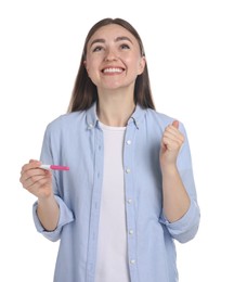 Photo of Happy woman holding pregnancy test on white background