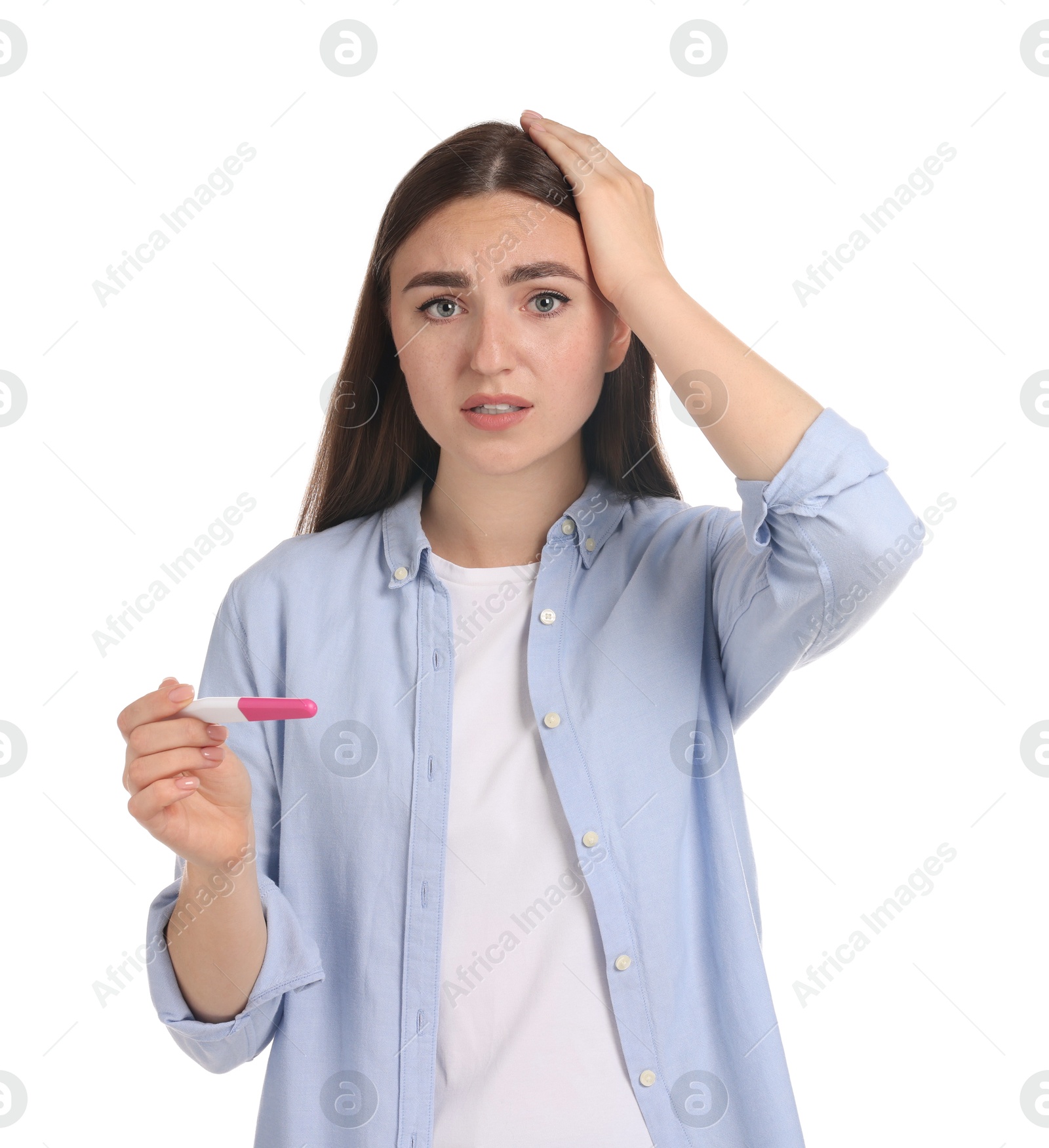 Photo of Confused woman holding pregnancy test on white background