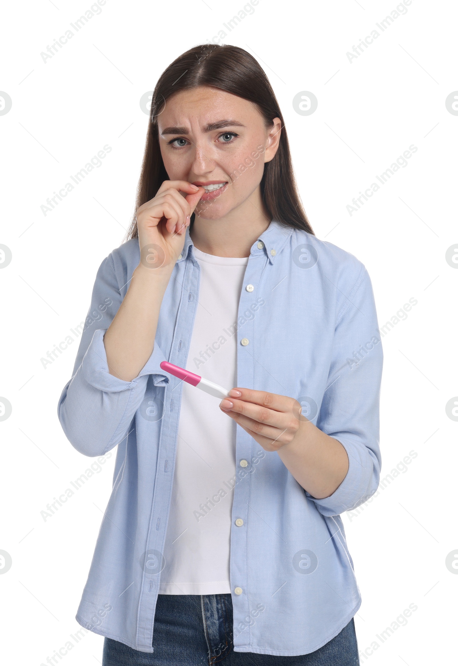 Photo of Confused woman holding pregnancy test on white background