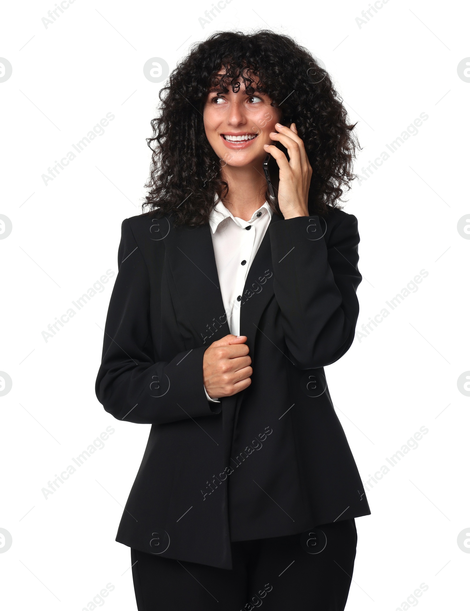 Photo of Beautiful young woman in black suit talking on smartphone against white background