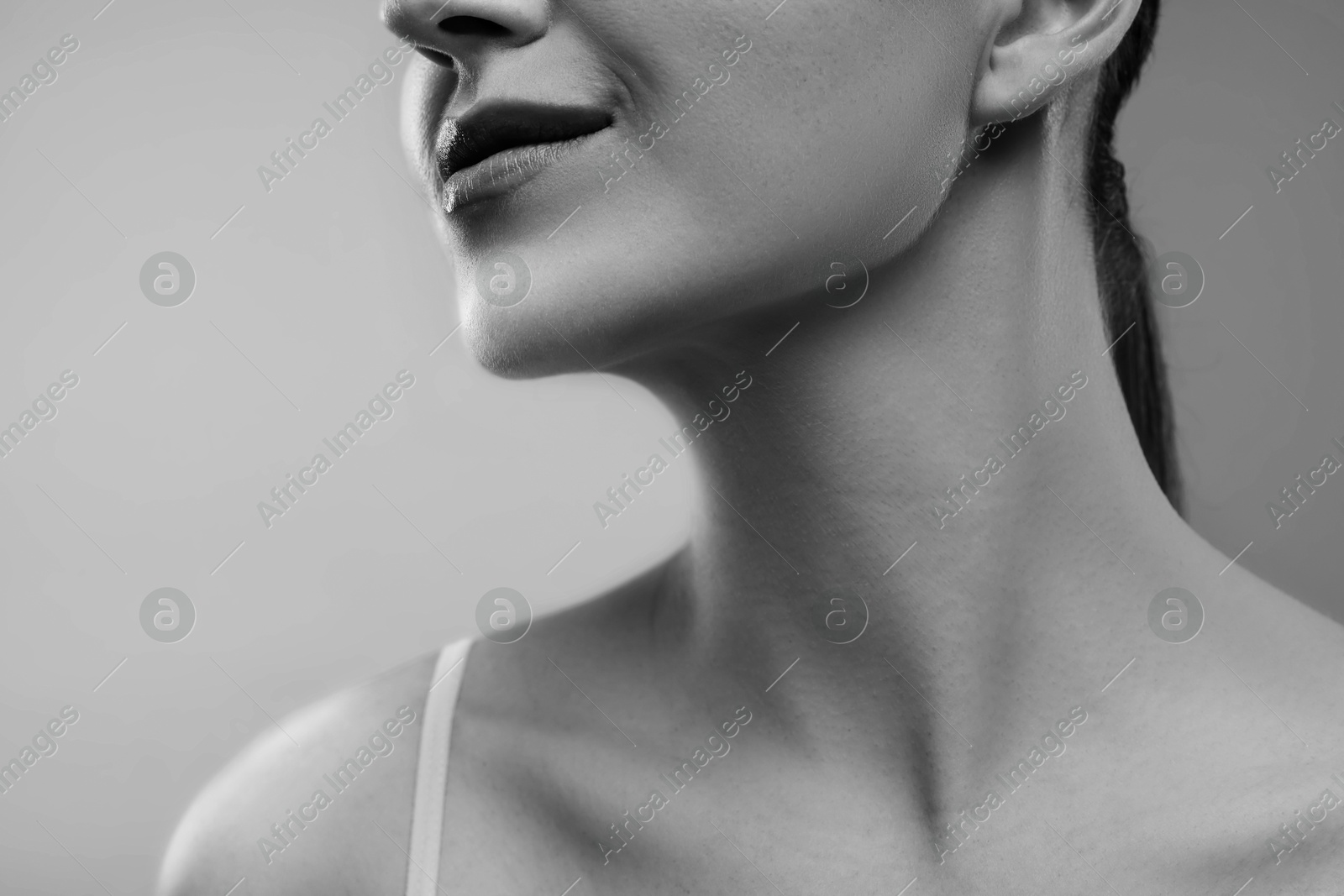 Image of Gorgeous woman showing her beautiful neck, closeup. Black and white effect