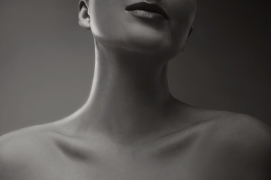 Gorgeous woman showing her beautiful neck, closeup. Black and white effect