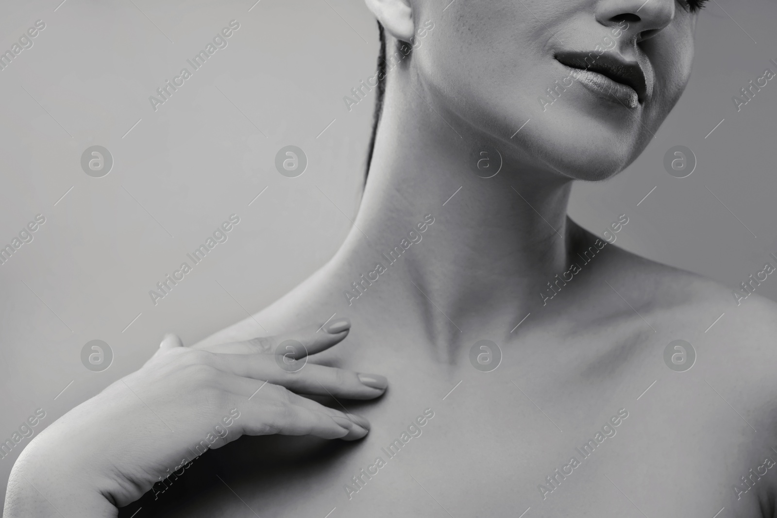 Image of Gorgeous woman showing her beautiful neck, closeup. Black and white effect