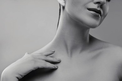 Gorgeous woman showing her beautiful neck, closeup. Black and white effect