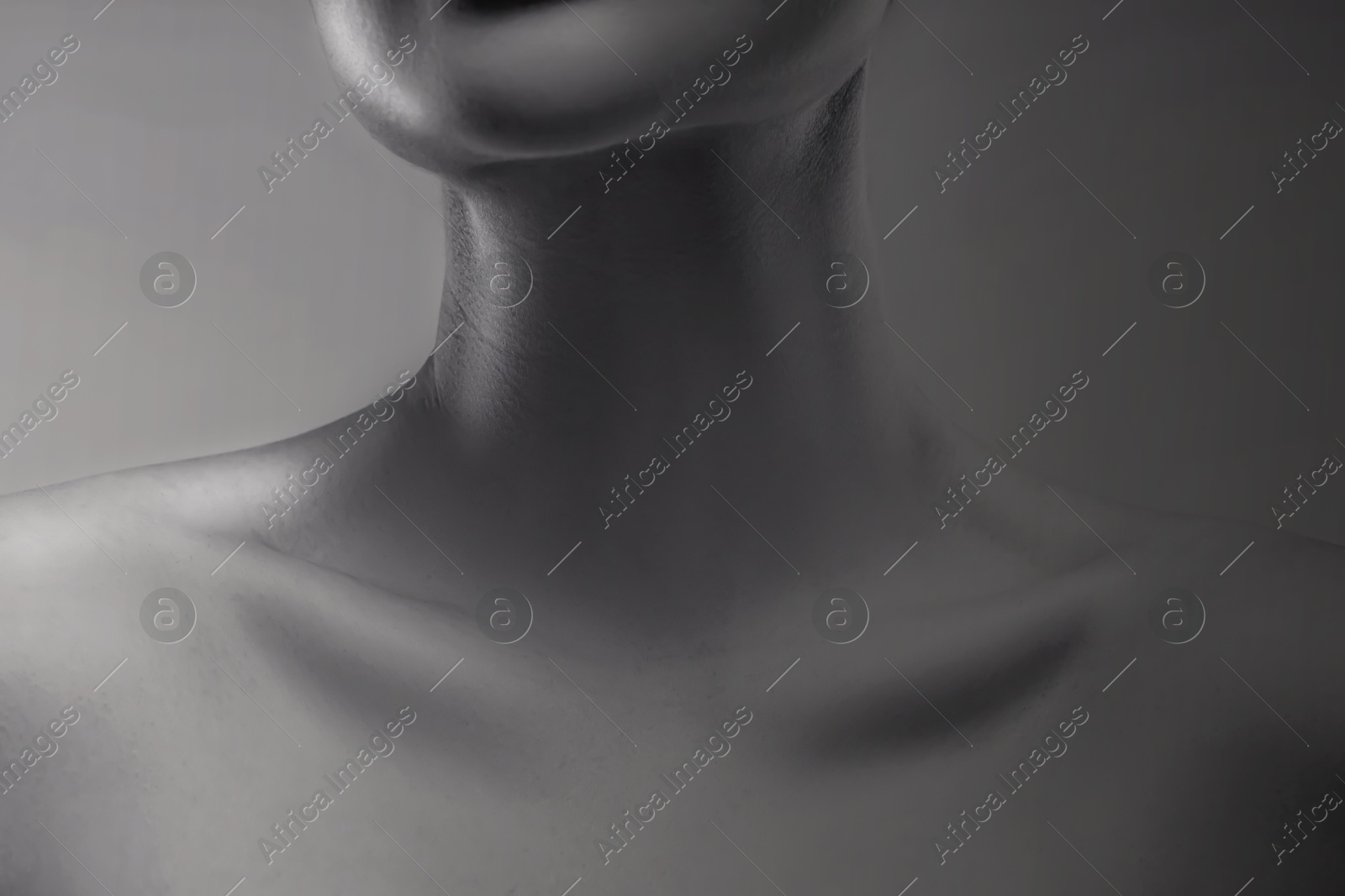 Image of Gorgeous woman showing her beautiful neck, closeup. Black and white effect