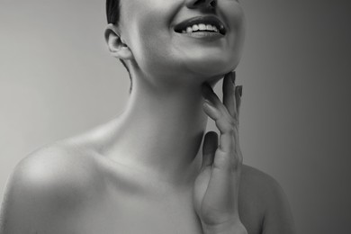 Image of Gorgeous woman showing her beautiful neck, closeup. Black and white effect