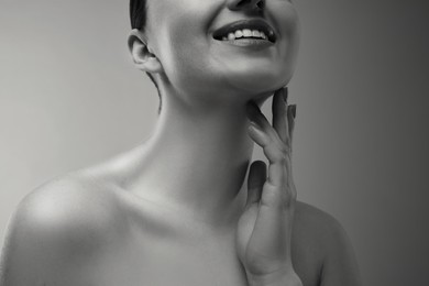 Gorgeous woman showing her beautiful neck, closeup. Black and white effect