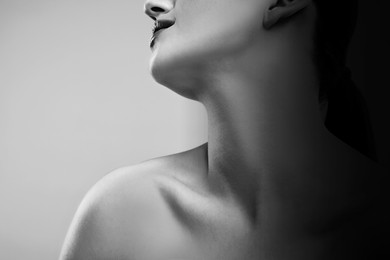 Image of Gorgeous woman showing her beautiful neck, closeup. Black and white effect