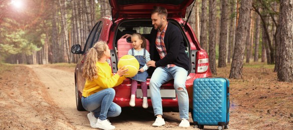 Image of Family with suitcases and car in forest on sunny morning. Banner design