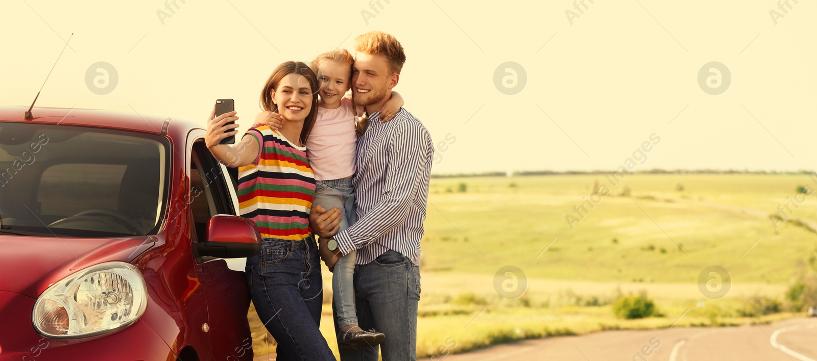 Image of Happy family taking selfie near car on road trip. Banner design