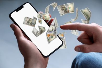 Image of Man using smartphone on grey background, closeup. Money flying out of device display