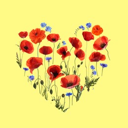 Heart made of meadow flowers on yellow background