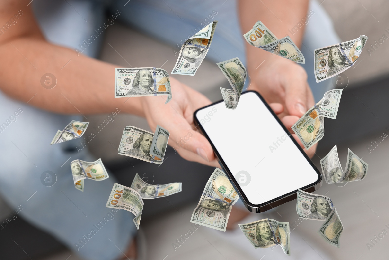 Image of Man using smartphone at home, closeup. Money flying around device