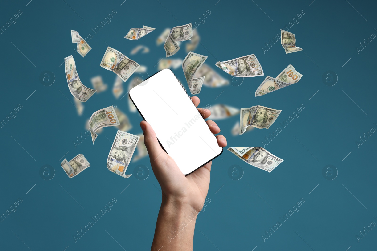 Image of Man showing smartphone with blank screen on light blue background, closeup. Money flying around device