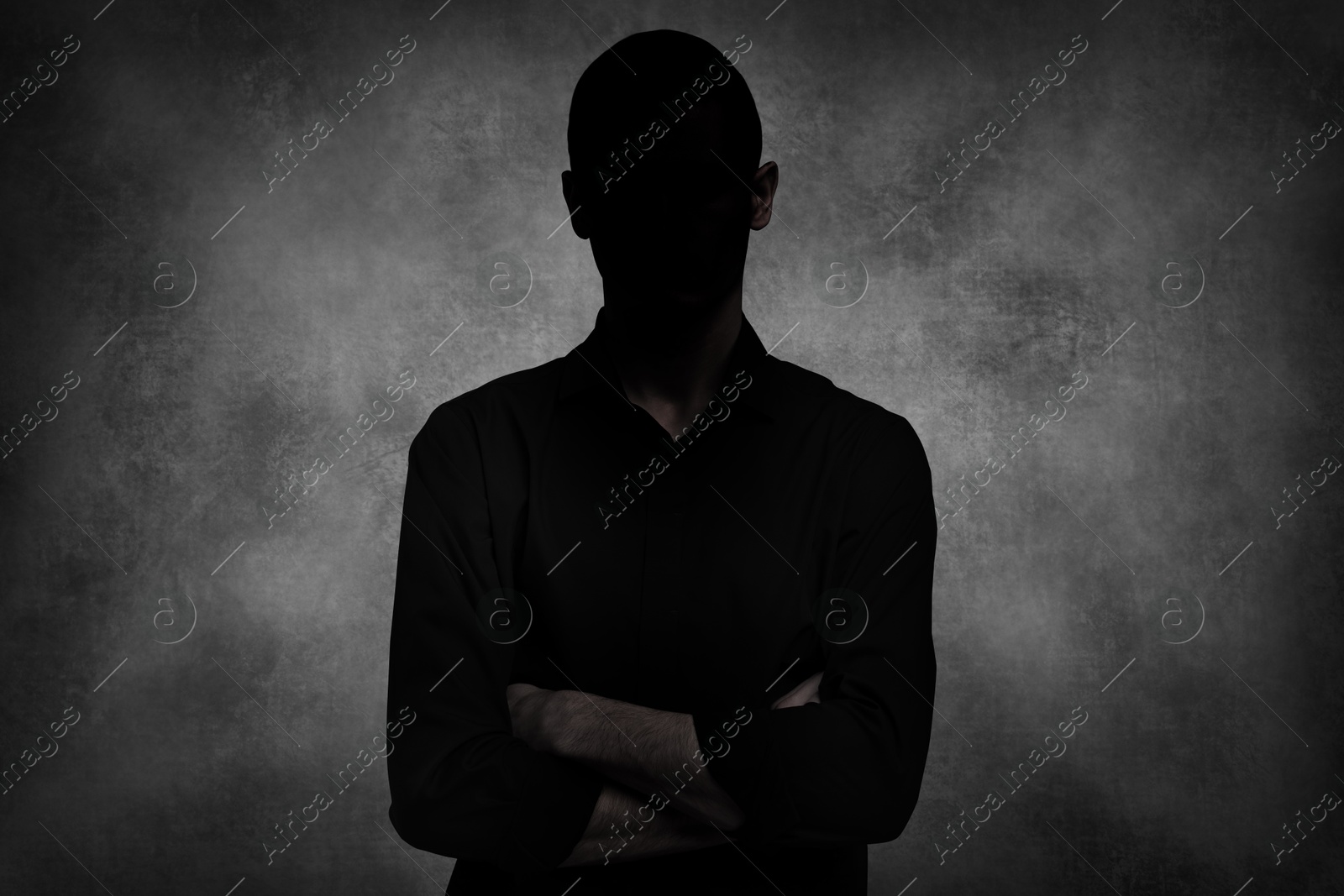 Image of Anonymous person. Shaded portrait of man on grey gradient background