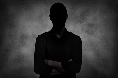 Image of Anonymous person. Shaded portrait of man on grey gradient background