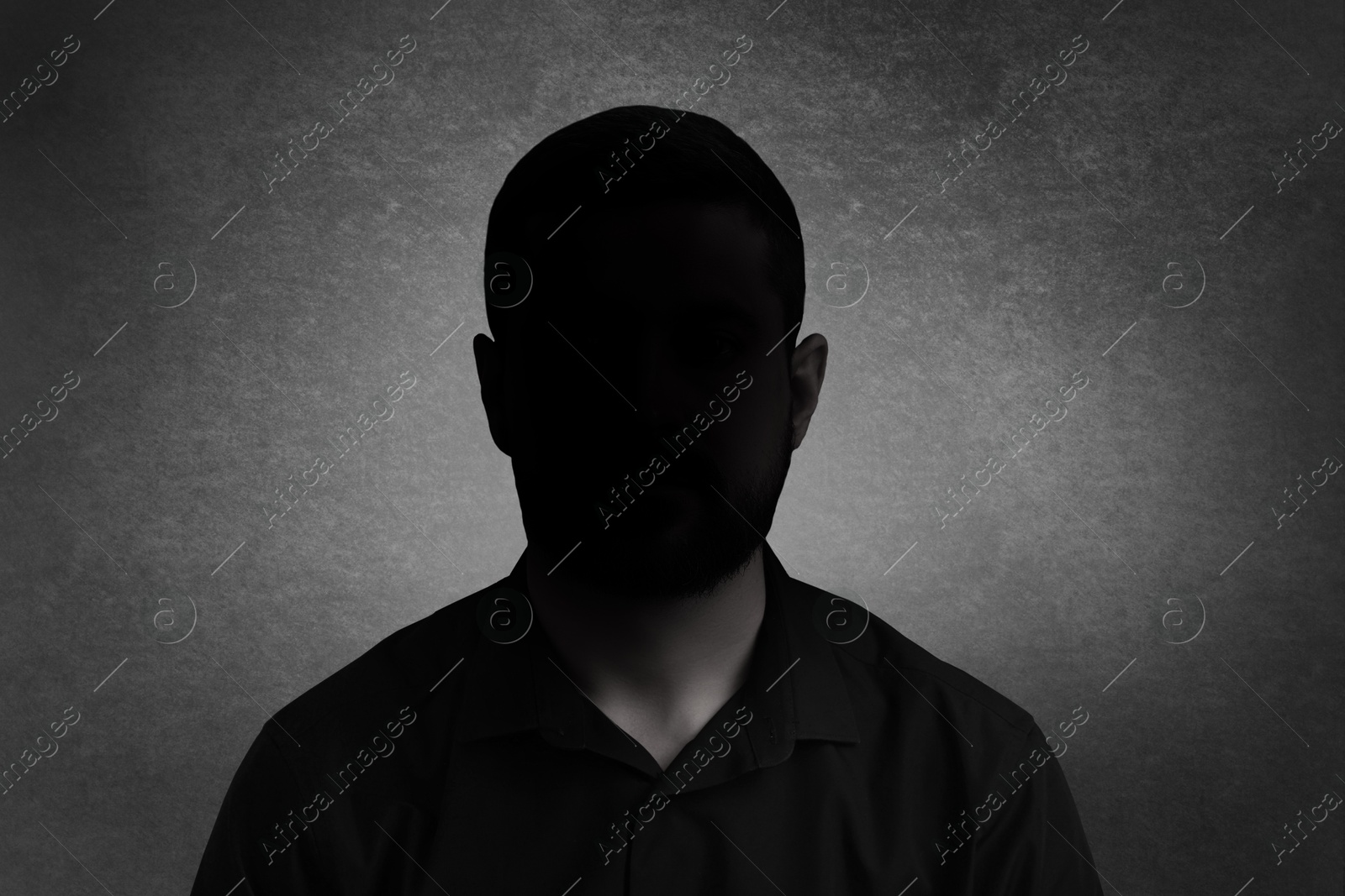 Image of Anonymous person. Shaded portrait of man on grey gradient background