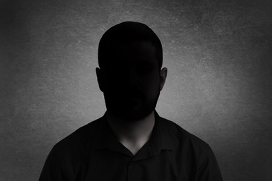 Anonymous person. Shaded portrait of man on grey gradient background