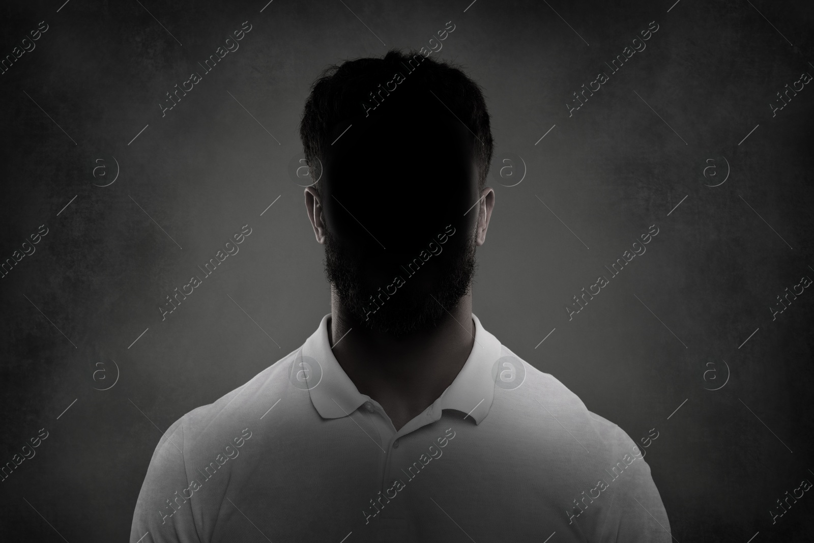 Image of Anonymous person. Shaded portrait of man on grey gradient background