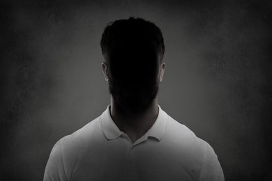 Anonymous person. Shaded portrait of man on grey gradient background