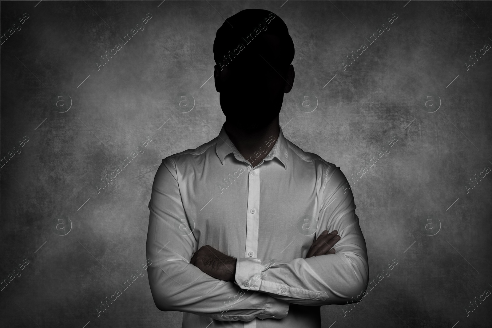 Image of Anonymous person. Shaded portrait of man on grey gradient background