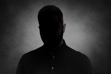 Anonymous person. Shaded portrait of man on grey gradient background