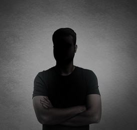 Image of Anonymous person. Shaded portrait of man on grey gradient background
