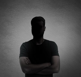 Anonymous person. Shaded portrait of man on grey gradient background