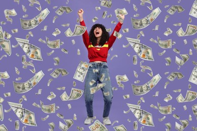 Happy woman under money rain on violet background