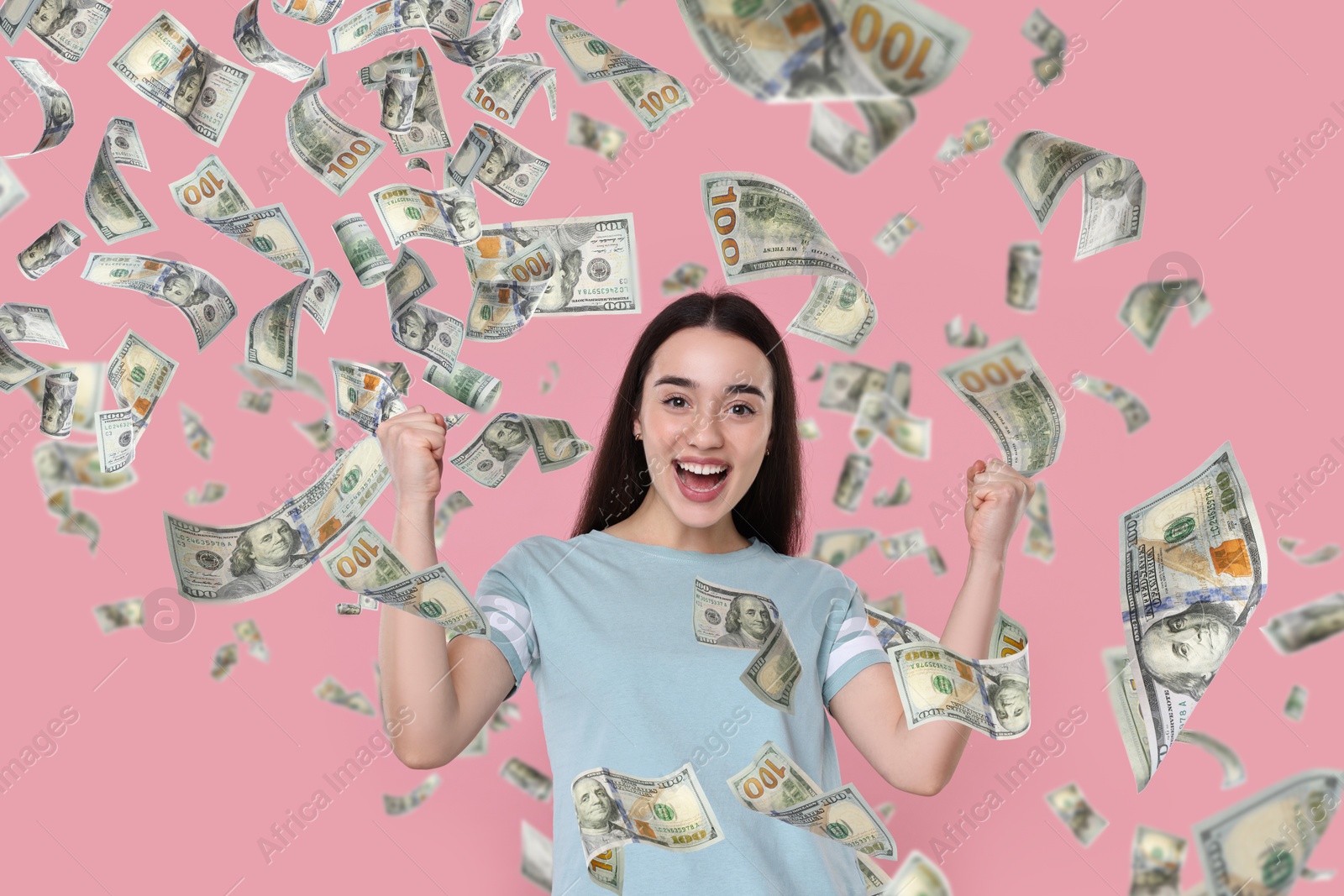 Image of Happy woman under money rain on pink background