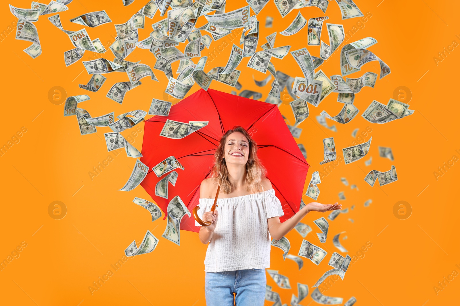 Image of Happy woman with umbrella under money rain on orange background