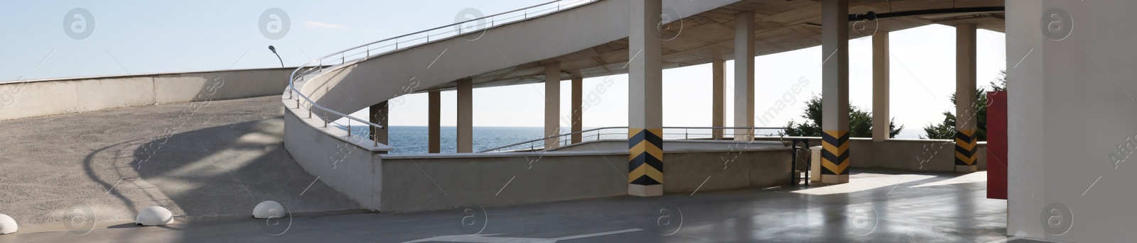 Image of Empty outdoor car parking lot with ramp on sunny day, banner design