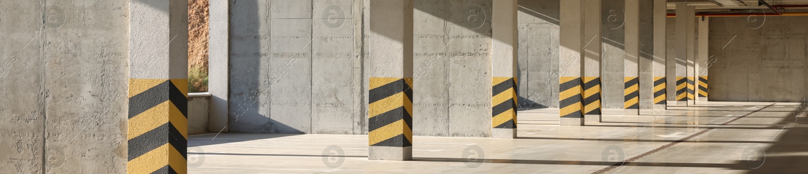 Image of Empty open car parking garage on sunny day, banner design